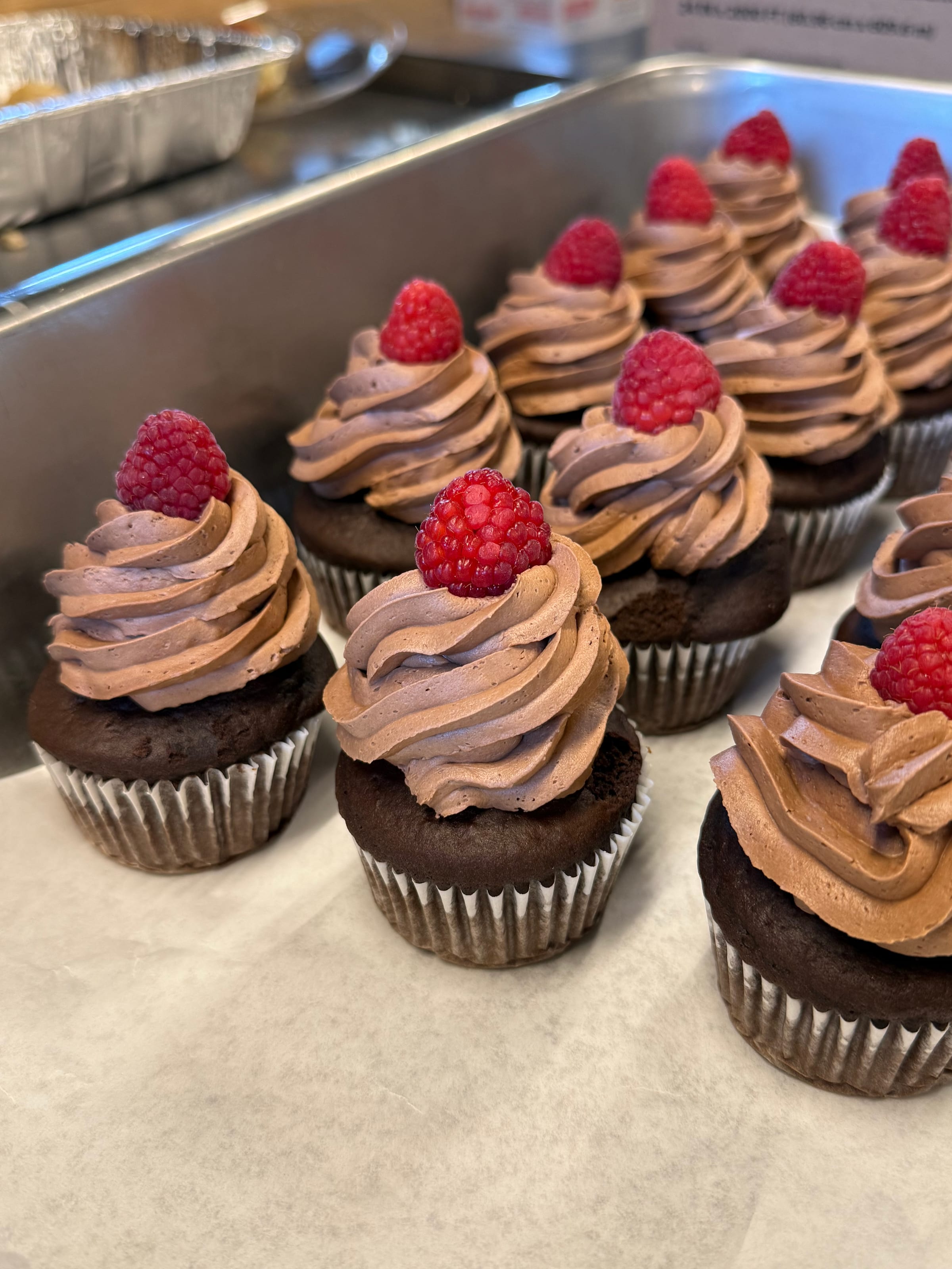 Chocolate cupcakes with chocolate buttercream and fresh raspberries